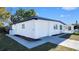 Corner exterior view of white home with garage and landscaped yard at 5712 Mallow St, New Port Richey, FL 34652