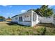 Front exterior of the home with a front porch with decorative rails at 5712 Mallow St, New Port Richey, FL 34652