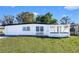 Charming single-story home with white painted brick, decorative trim, and well-maintained lawn at 5712 Mallow St, New Port Richey, FL 34652