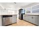 Modern kitchen with granite countertops, gray cabinets, stainless steel appliances, and wood-look floors at 5712 Mallow St, New Port Richey, FL 34652