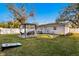 Spacious backyard featuring a pergola with seating, lush green lawn, and white fencing at 5713 23Rd S Ave, Gulfport, FL 33707