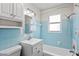 Bright bathroom features a tub with shower, single sink vanity, and tiled walls at 5713 23Rd S Ave, Gulfport, FL 33707