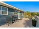 Outdoor deck area featuring a table, chairs, and stylish potted flowers, perfect for entertaining at 5713 23Rd S Ave, Gulfport, FL 33707