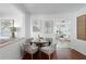 Charming dining area with seating for four, elegant decor, and views into the sunny living room at 5713 23Rd S Ave, Gulfport, FL 33707