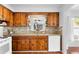 Functional kitchen featuring wood cabinetry, mosaic backsplash, and an abundance of natural light from the window at 5713 23Rd S Ave, Gulfport, FL 33707
