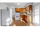 Bright kitchen has updated appliances, warm wood cabinets and hardwood floors at 5713 23Rd S Ave, Gulfport, FL 33707