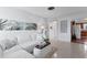 Open-concept living room with modern decor, a comfortable sofa, and seamless flow to dining area at 5713 23Rd S Ave, Gulfport, FL 33707
