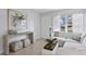 Bright living room featuring a comfortable white sofa, stylish decor, and natural light at 5713 23Rd S Ave, Gulfport, FL 33707