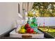 Outdoor tray with apples, sparkling water, and double good popcorn near a green lawn at 5713 23Rd S Ave, Gulfport, FL 33707