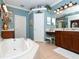 This bathroom offers a vanity with dark wood cabinets and a soaking tub at 6276 Wingspan Way, Bradenton, FL 34203