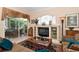 Comfortable living room featuring a fireplace, stained glass window, and lots of natural light at 6276 Wingspan Way, Bradenton, FL 34203