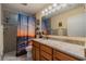 Bright bathroom showcasing a vanity with granite counters and a shower with a curtain at 663 Allegheny Dr, Sun City Center, FL 33573