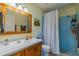 Bathroom featuring a modern vanity, toilet, and a blue bathtub-shower combination at 663 Allegheny Dr, Sun City Center, FL 33573