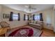 Bedroom with hardwood floors, a sofa, a rug, and natural light from two windows at 663 Allegheny Dr, Sun City Center, FL 33573