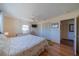 Bedroom with hardwood floors, a ceiling fan, lots of closet space, and access to another room at 663 Allegheny Dr, Sun City Center, FL 33573