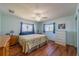 Cozy bedroom with hardwood floors, ceiling fan, and natural light from two windows at 663 Allegheny Dr, Sun City Center, FL 33573
