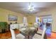Inviting dining room features a glass-top table with seating for six, a modern chandelier, and hardwood floors at 663 Allegheny Dr, Sun City Center, FL 33573