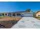 A lovely single-story home boasting a geometrically patterned driveway and solar panels on the roof at 663 Allegheny Dr, Sun City Center, FL 33573