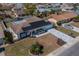Aerial view of a single-story home with solar panels, patterned driveway, and neatly landscaped front yard at 663 Allegheny Dr, Sun City Center, FL 33573