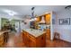 Stylish kitchen with a granite island, stainless steel appliances, and warm wood cabinetry, creating a welcoming space at 663 Allegheny Dr, Sun City Center, FL 33573