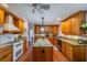 Open kitchen with a center island, granite countertops, and plenty of cabinet storage at 663 Allegheny Dr, Sun City Center, FL 33573