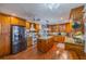 Spacious kitchen features granite countertops, stainless steel appliances, a central island, and ample cabinetry at 663 Allegheny Dr, Sun City Center, FL 33573