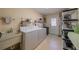 Functional laundry room with washer, dryer, utility sink, and ample storage shelving at 663 Allegheny Dr, Sun City Center, FL 33573