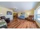 Inviting living room with hardwood floors, a ceiling fan, and lots of natural light at 663 Allegheny Dr, Sun City Center, FL 33573