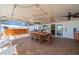 Spacious covered patio with outdoor kitchen, dining area, and comfortable seating at 663 Allegheny Dr, Sun City Center, FL 33573