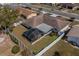 Aerial view of a home with a screened lanai and a well-maintained, fenced yard in a residential neighborhood at 663 Allegheny Dr, Sun City Center, FL 33573