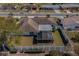 Aerial view of a home featuring a screened lanai and fenced-in backyard with manicured lawn and garden at 663 Allegheny Dr, Sun City Center, FL 33573
