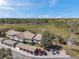 Aerial view of condo complex with carport parking, and a scenic wooded backdrop at 6701 River Run Blvd, Weeki Wachee, FL 34607