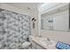 Bathroom with blue sea-themed decor, tile flooring, and a shower-tub combination at 6701 River Run Blvd, Weeki Wachee, FL 34607