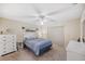 Comfortable bedroom featuring neutral tones, a ceiling fan, and ample natural light at 6701 River Run Blvd, Weeki Wachee, FL 34607