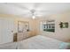 Comfortable bedroom featuring natural light from the window and a dresser with a mirror at 6701 River Run Blvd, Weeki Wachee, FL 34607