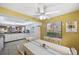 Bright eat-in kitchen boasts white cabinetry, a window, and a ceiling fan, perfect for casual dining at 6701 River Run Blvd, Weeki Wachee, FL 34607