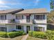 Condo exterior featuring a private balcony and manicured shrubbery at 6701 River Run Blvd, Weeki Wachee, FL 34607