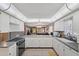 Open kitchen featuring stainless steel appliances and a view of the living room at 6701 River Run Blvd, Weeki Wachee, FL 34607