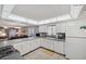 Open kitchen with white cabinetry, stainless appliances, and breakfast bar at 6701 River Run Blvd, Weeki Wachee, FL 34607