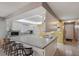 Bright and open kitchen with breakfast bar and white cabinets, flowing into the dining area at 6701 River Run Blvd, Weeki Wachee, FL 34607
