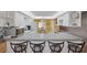 Open kitchen with white cabinets, breakfast bar, and stainless steel microwave at 6701 River Run Blvd, Weeki Wachee, FL 34607