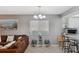 Inviting living area showcasing an elegant lighting fixture and a seamless transition to the kitchen at 6701 River Run Blvd, Weeki Wachee, FL 34607