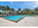 Community pool with clear blue water and plenty of chairs for lounging at 6701 River Run Blvd, Weeki Wachee, FL 34607