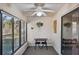 Relaxing sunroom with large windows, ceiling fan, and backyard views at 6701 River Run Blvd, Weeki Wachee, FL 34607