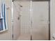 Shower features tile surround and glass sliding doors at 6701 River Run Blvd, Weeki Wachee, FL 34607