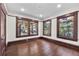 Bedroom with new hardwood floors and large windows with dark wood trim offering ample natural light at 710 E Plymouth St, Tampa, FL 33603