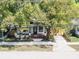 Charming home featuring a cozy front porch, lush landscaping, and a welcoming walkway at 710 E Plymouth St, Tampa, FL 33603