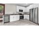 Beautiful kitchen with marble floors, stainless steel appliances, granite countertops, and white cabinetry at 710 E Plymouth St, Tampa, FL 33603