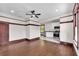 Open-concept living room featuring dark wood floors, updated lighting, and an adjacent kitchen area at 710 E Plymouth St, Tampa, FL 33603