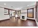 Spacious living room with fireplace and beautiful wood floors; open to kitchen and dining at 710 E Plymouth St, Tampa, FL 33603